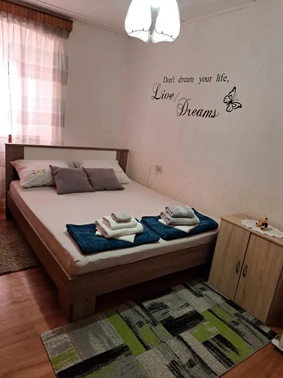 Bedroom with a large double bed and fresh towels